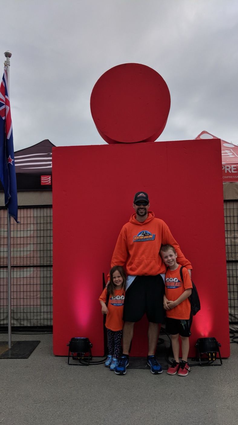 With my kids under the Ironman logo at a race village
